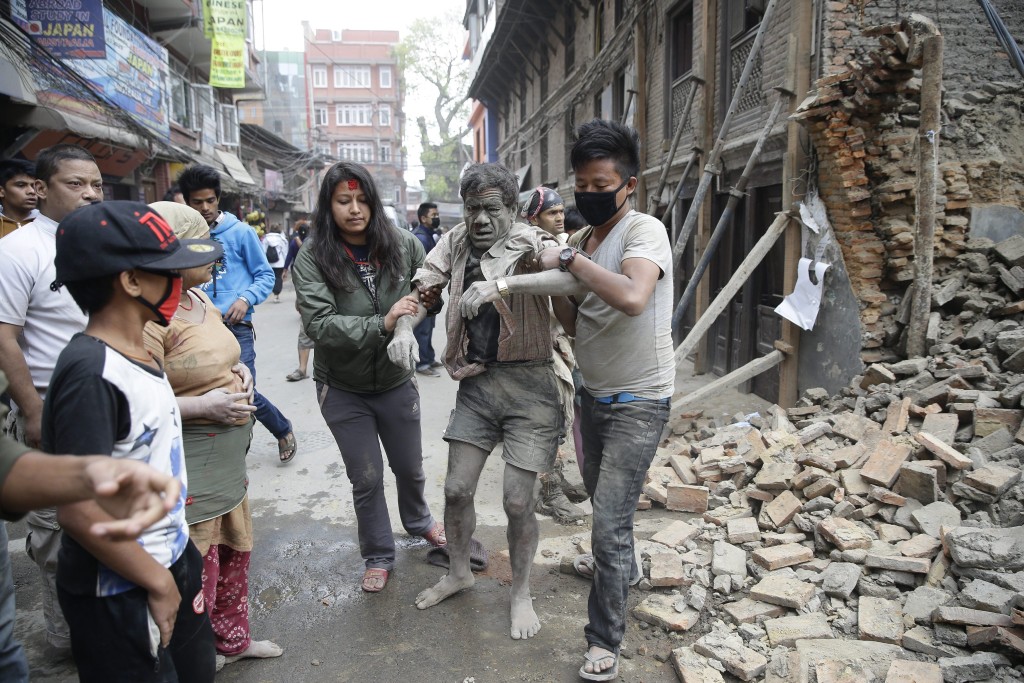 epaselect epa04719891 People free a man from the rubble of a destroyed building after an earthquake hit Nepal, in Kathmandu, Nepal, 25 April 2015. A 7.9-magnitude earthquake rocked Nepal destroying buildings in Kathmandu and surrounding areas, with unconfirmed rumours of casualties. The epicentre was 80 kilometres north-west of Kathmandu, United States Geological Survey. Strong tremors were also felt in large areas of northern and eastern India and Bangladesh. EPA/NARENDRA SHRESTHA